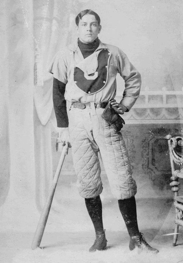 Baseball history photo:  Arthur Van Winkler, Centre College baseball player, 1891. Note the primitive fielder's glove, devoid of padding.  Even by 1891, gloves for players other than the catcher were slowly developing.  Winkler may have been a pitcher as is evidence to the fact that his right uniform sleeve has been tailored into a short sleeve.  The bat he is leaning on shows only small taper from the 2½ inch barrel to the handle which was the standard in the 19th century.  Winkler's baseball pants are also fully padded as seen by the quilt stitched pattern.  Ads for sliding pads first appeared in the 1887 Spalding's Official Base Ball Guide as Morton's Patent Sliding Pad.  This was a quilted piece of material that was strapped to the player's leg, on top of his pants, covering the hip and thigh just above the knee.  It was available in chamois and canvas and according to the ad, Its use increases a player's confidence, and renders the act of sliding free from danger. The following year Spalding offered baseball pants with the padding stitched into the game pants, at an extra cost, as well as the Morton sliding pad.  Click photo to return to previous page.