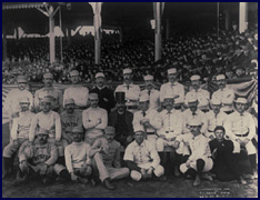 1886 Boston/New York team photo. Charles “Old Hoss” Radbourn is first from left standing with middle finger covertly extended. Click to enlarge.