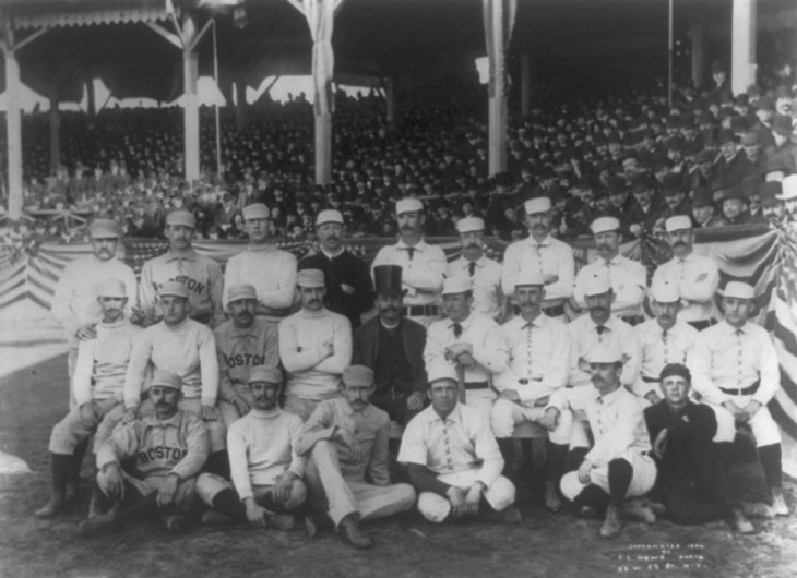 Baseball history photo: 1886 Boston/New York team photo. Charles “Old Hoss” Radbourn is first from left standing with middle finger covertly extended. Click photo to return to previous page.